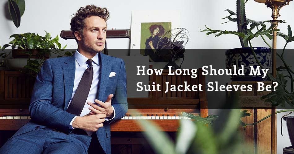 Man sitting in front of piano wearing a blue suit with text reading How Long Should My Suit Jacket Sleeves Be?