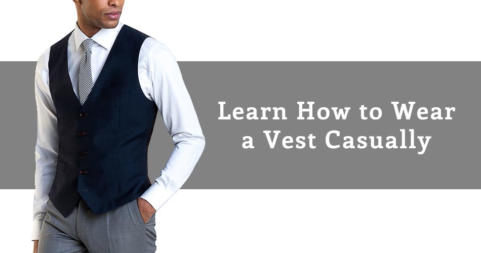 man wearing navy vext with gray tie and gray dress pants with text overlay reading "Learn How to Wear a Vest Casually"