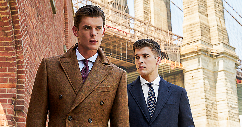 L-R: Custom Double-Breasted Topcoat in Tobacco Brown and Custom Single Breasted Topcoat in Blue Herringbone both by Black Lapel.