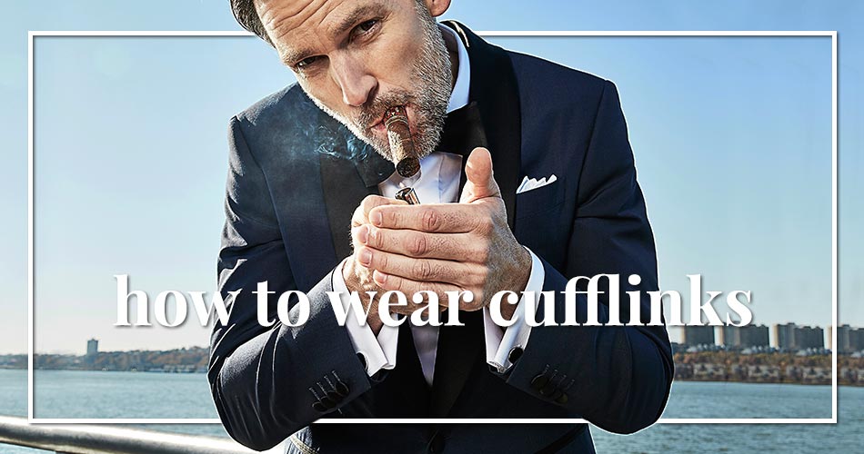 man in a blue tuxedo smoking a cigar with his back to a river with text overlay that reads how to wear cufflinks