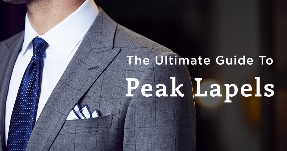 man wearing gray suit with blue tie and peak lapel with text overlay "The Ultimate Guide To Peak Lapels"
