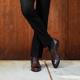 man wearing black suit pants with brown shoes