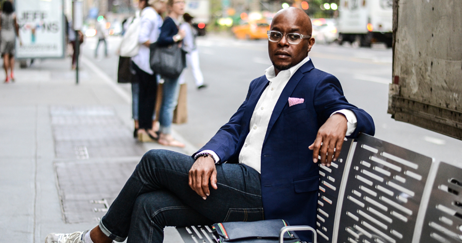 man with a blue blazer on sitting on a bench