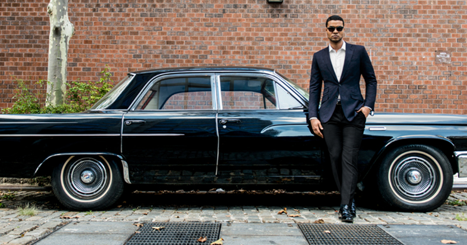 man with a suit in front of a car