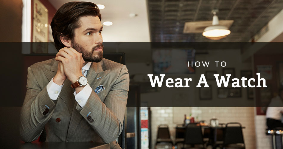 man wearing striped suit with text that reads how to wear a watch