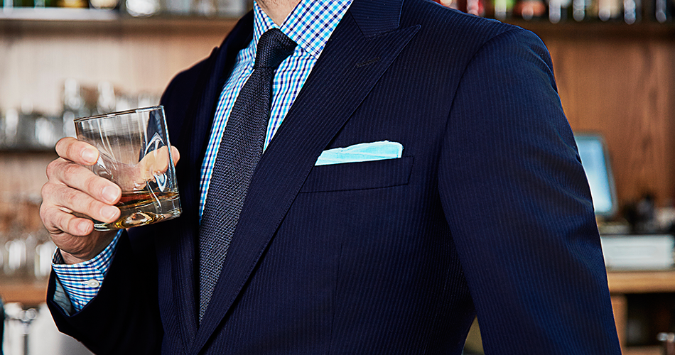 rehearsal dinner suit with whiskey glass