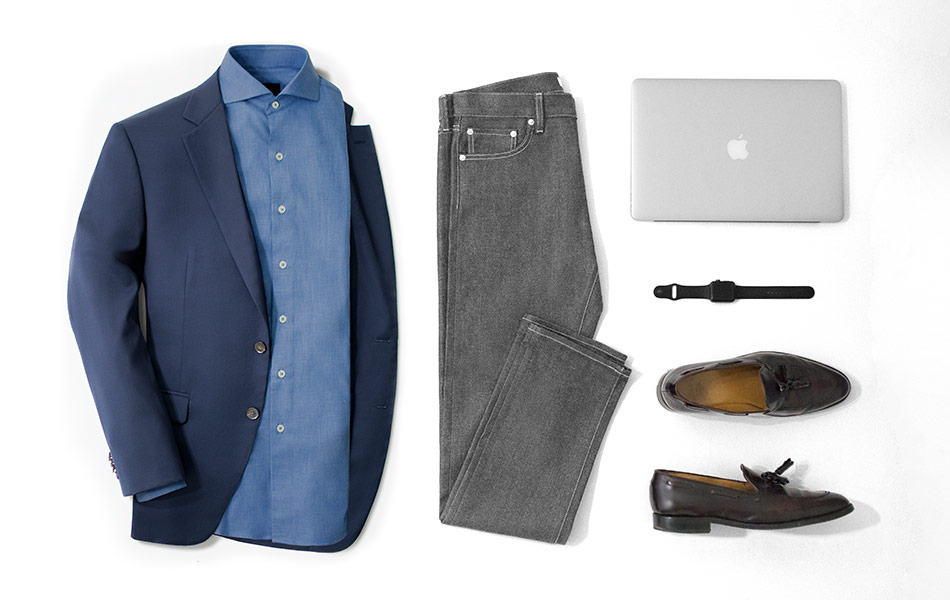 navy blazer combination with gray jeans and brown loafers with a laptop and watch