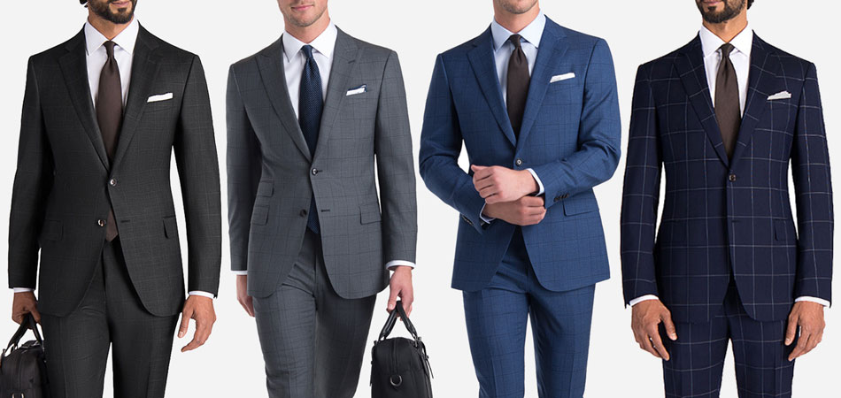 four men wearing black, gray, blue, and navy windowpane suits against a white background