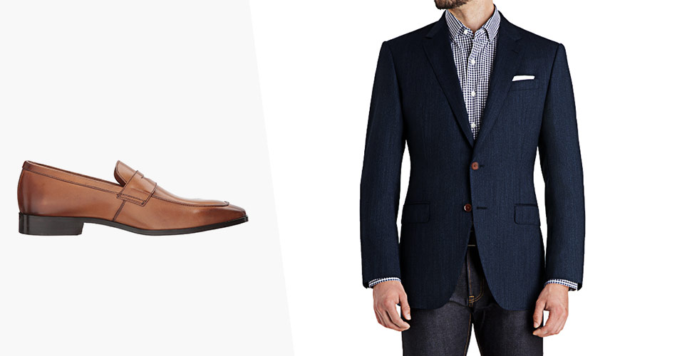 a sideview of brown penny loafers paired with a man wearing navy blazer and dark jeans