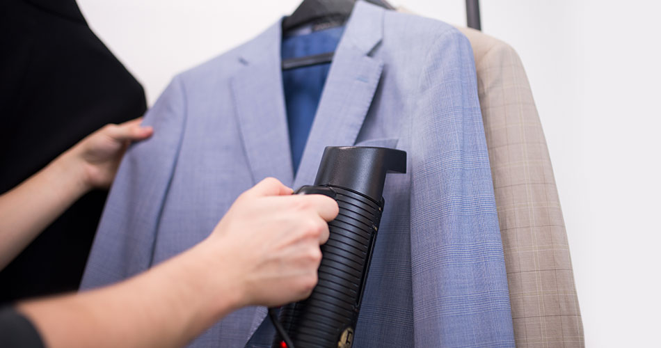 man steaming a blue suit blazer