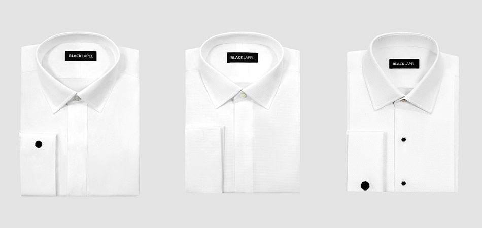 three folded white tuxedo shirts on a light gray background