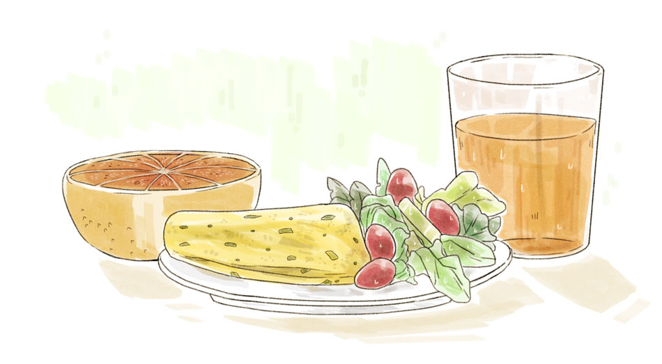 healthy breakfast of an egg omelette, salad, grapefruit, and orange juice