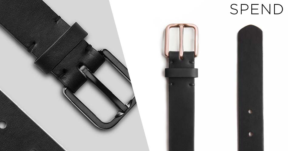 suit accessory black leather belt close up with dark metal buckle and on white background with rose gold buckle