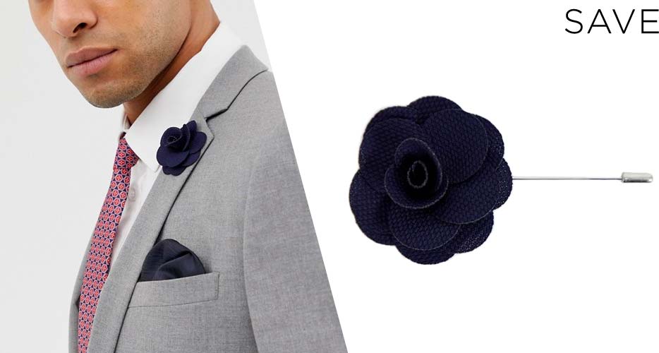 navy blue flower suit accessory lapel pin on white background and on a man wearing gray suit