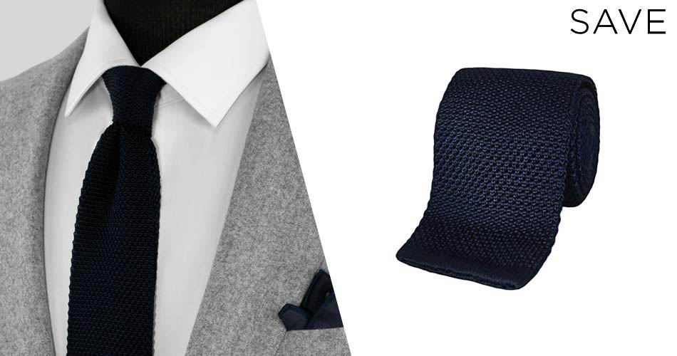 textured knitnavy suit accessory tie on a dressform and rolled and on a white background