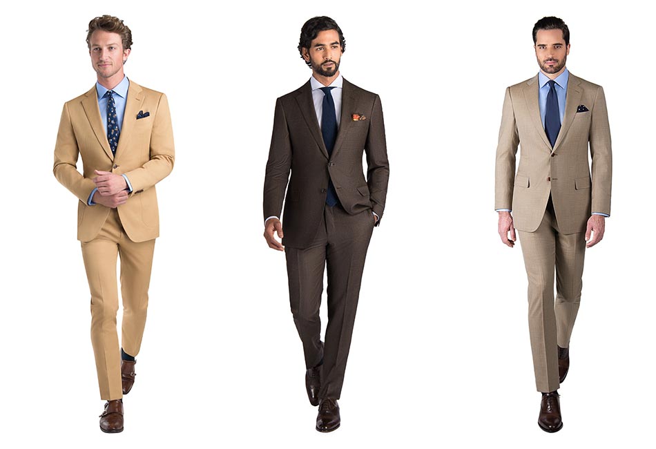 from left to right: man wearing a khaki suit with blue tie, man wearing a brown suit with navy tie, man wearing a tan suit with blue tie