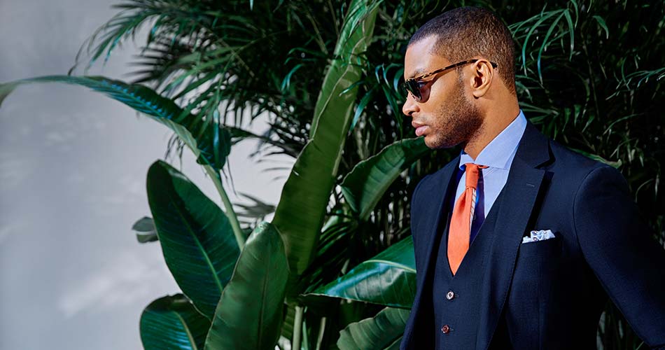 man wearing three piece linen suit and sunglasses